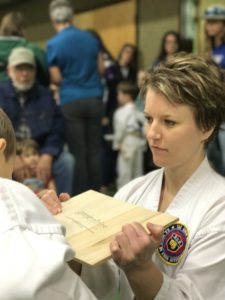 A student holds a board donated by Great Plains College